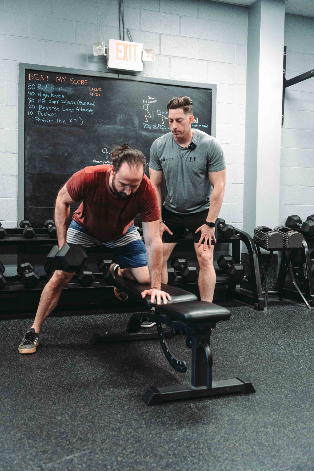 Dumbbell Rows - Man Doing Dumbbell Rows With Personal Trainer