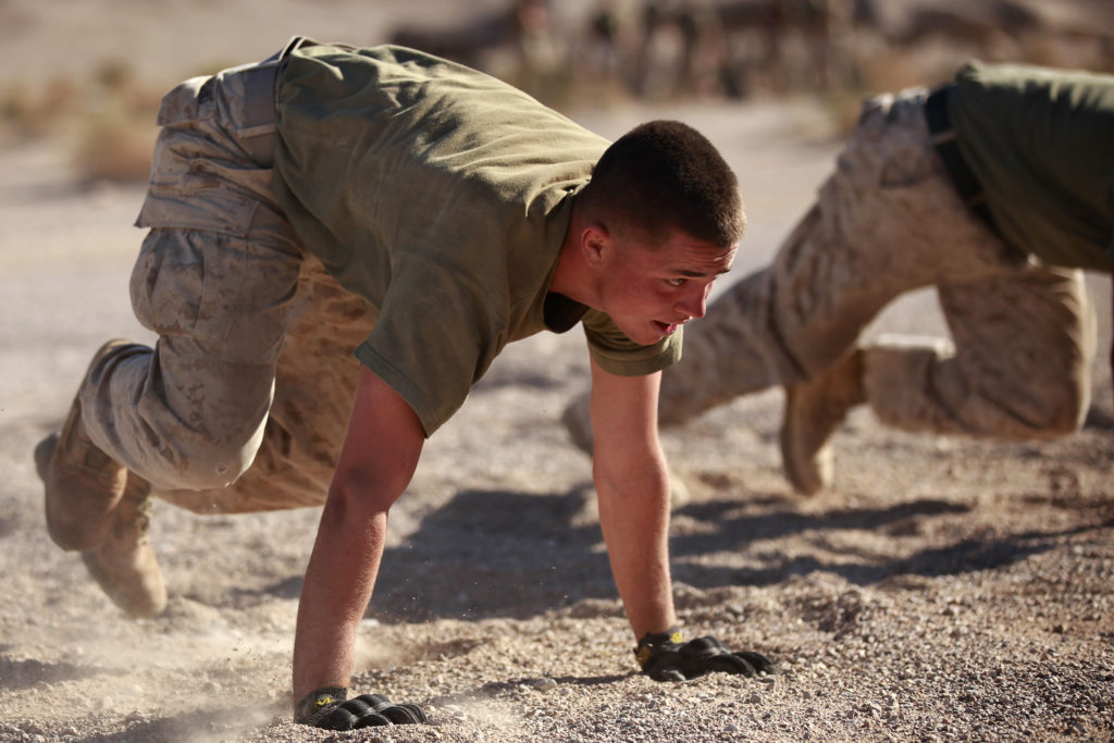 MARINE CORPS AIR GROUND COMBAT CENTER, TWENTYNINE PALMS, Calif., Ca - A Marine with Fox Company, 2nd Battalion, 3rd Marine Regiment, does mountain climbers during a physical training time while the unit is conducting the Integrated Training Exercise at the Marine Corps Air Ground Combat Center Twentynine Palms, Calif., Sept. 17, 2013. (U.S. Marine Corps photo by Cpl. Sarah Dietz)